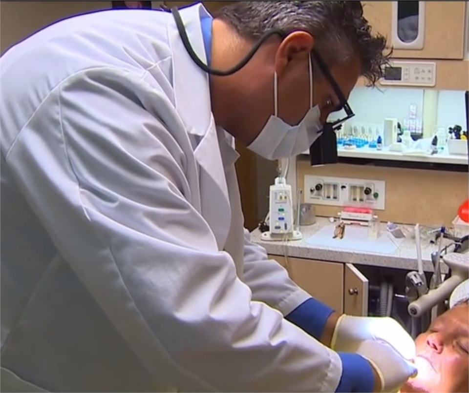 Seattle dentist Dr. Timmerman at work in his operatory Dentagama
