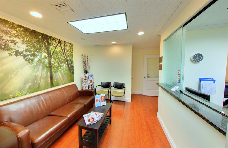 waiting area and front desk at our general dentistry office located opposite Hallandale Beach 