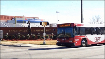 FAST city bus passing Fayetteville State University 6 miles away from O2 Dental Group of Fayettevill