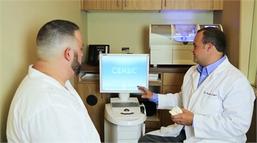Dr. Carlos Lopez of Riggs Family Dental explaining CEREC same day crowns to patient
