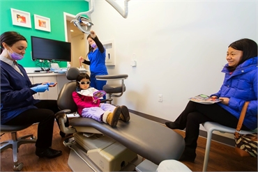 Dr. Ciano of Montgomery Pediatric Dentistry explains a dental procedure to her pediatric patient