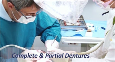 Denture specialists working on a patient at Powell Family Dental Care