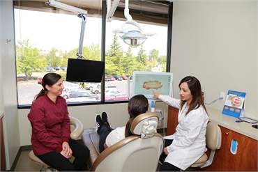 Renton dentist Dr. Pawandeep Kaur at Renton Smile Dentistry explains procedure to patient using iTer