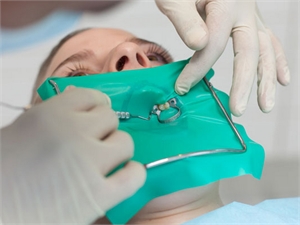 What is a rubber dental dam?