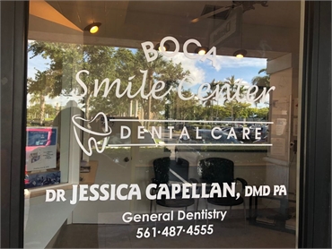 Signage on glass pane at Boca Smile Center