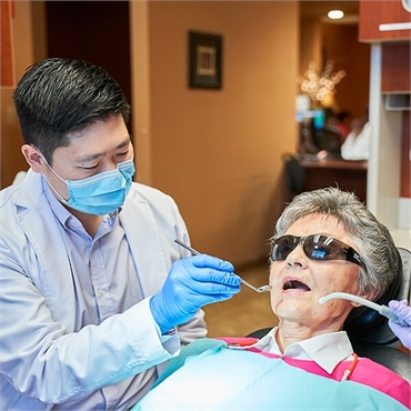 Renton dentist Dr Hu with an elderly patient at Hu Smiles in Renton