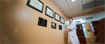 Renton cosmetic dentist Dr Hu with their Dental Degree at Hu Smiles