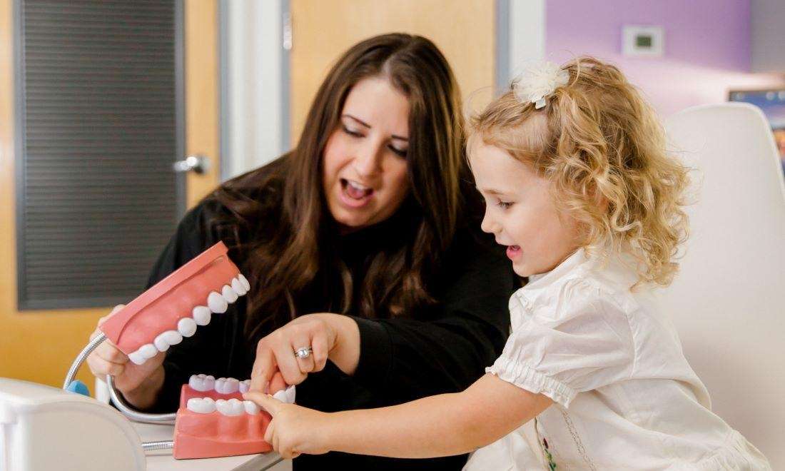 Dr Christen Massey DDS working with a young patient Dentagama