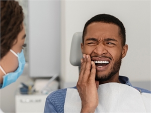 Patient in dental chair with tooth pain.