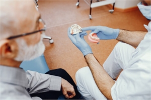 A old man consult with dentist about their dental treatment