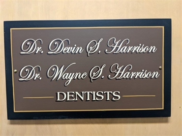 Signage on entrance door at Gloversville dentist Harrison Family Dentists