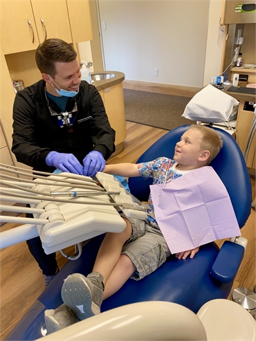 Greeley kids dentist Dr. Luker sharing a joke with his patient at Luker Dental