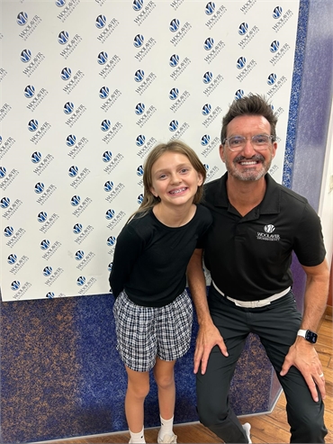 Dr Chris Woolaver with kid patient wearing braces