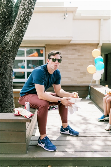 Forth Worth Medicaid pediatric dentist Dr. Justin Warcup relaxing outside his office Smile Team Pedi