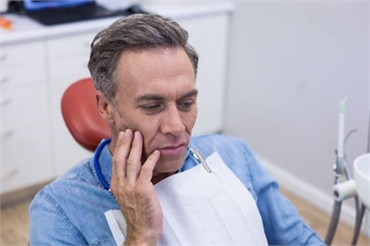 Patient with Tooth Pain in Dental Chair