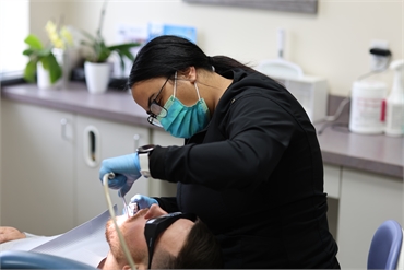 Dental hygienist with dental implants patient at Serenity Dental Spokane WA