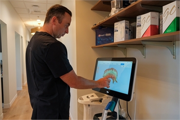 Roseville dentist Dr. Haney working on iTero intraoral scanner