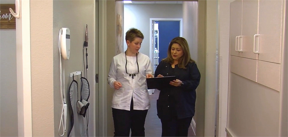 Richardson dentist Dr. Meredith Davis in the hallway with reception staff