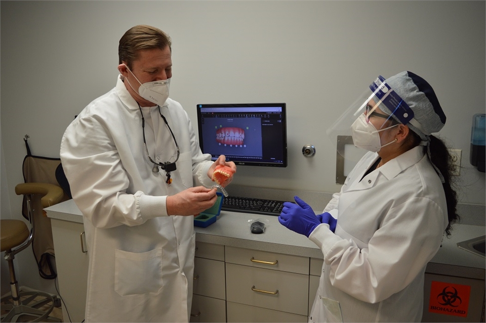 Elizabeth dentist Dr. Joseph Banker discussing invisalign patient with dental assistant at Banker De