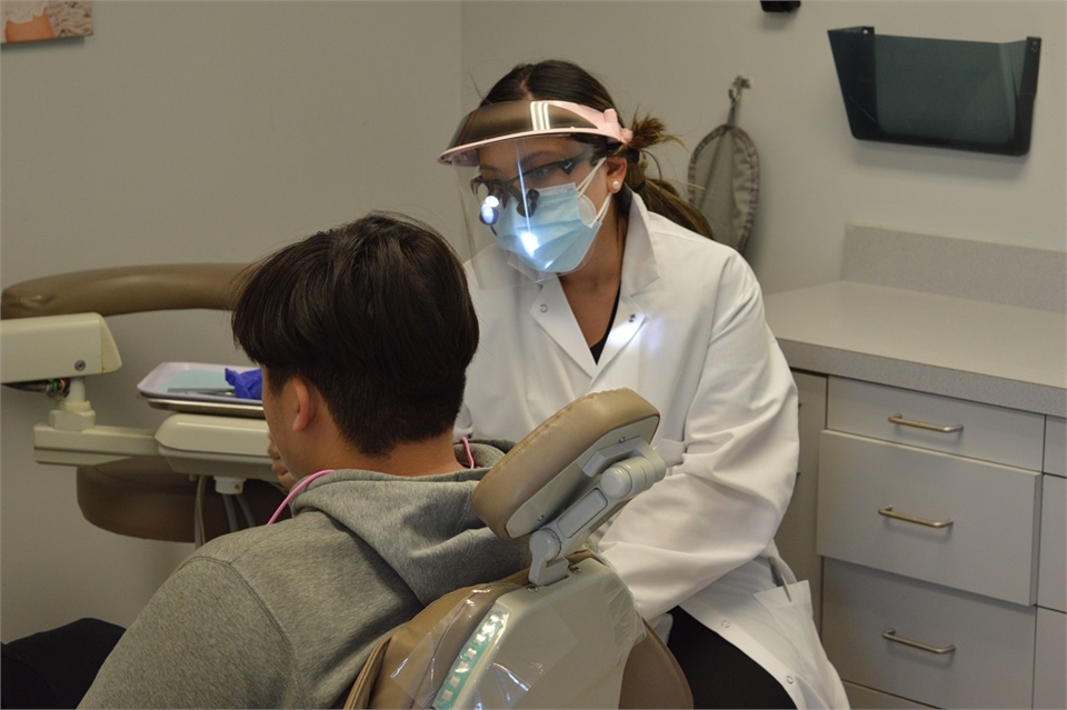 Elizabeth dentist Dr. Mary Pham talking to dental same crown patient at Banker Dental Associates