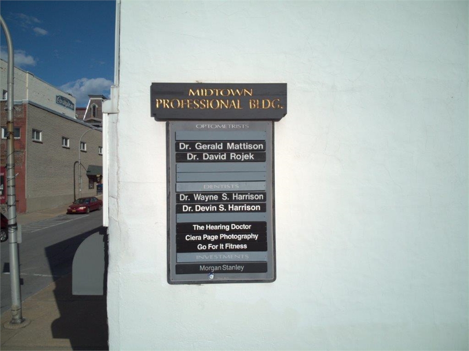 Signage on office building for Gloversville dentists Harrison Family Dentists