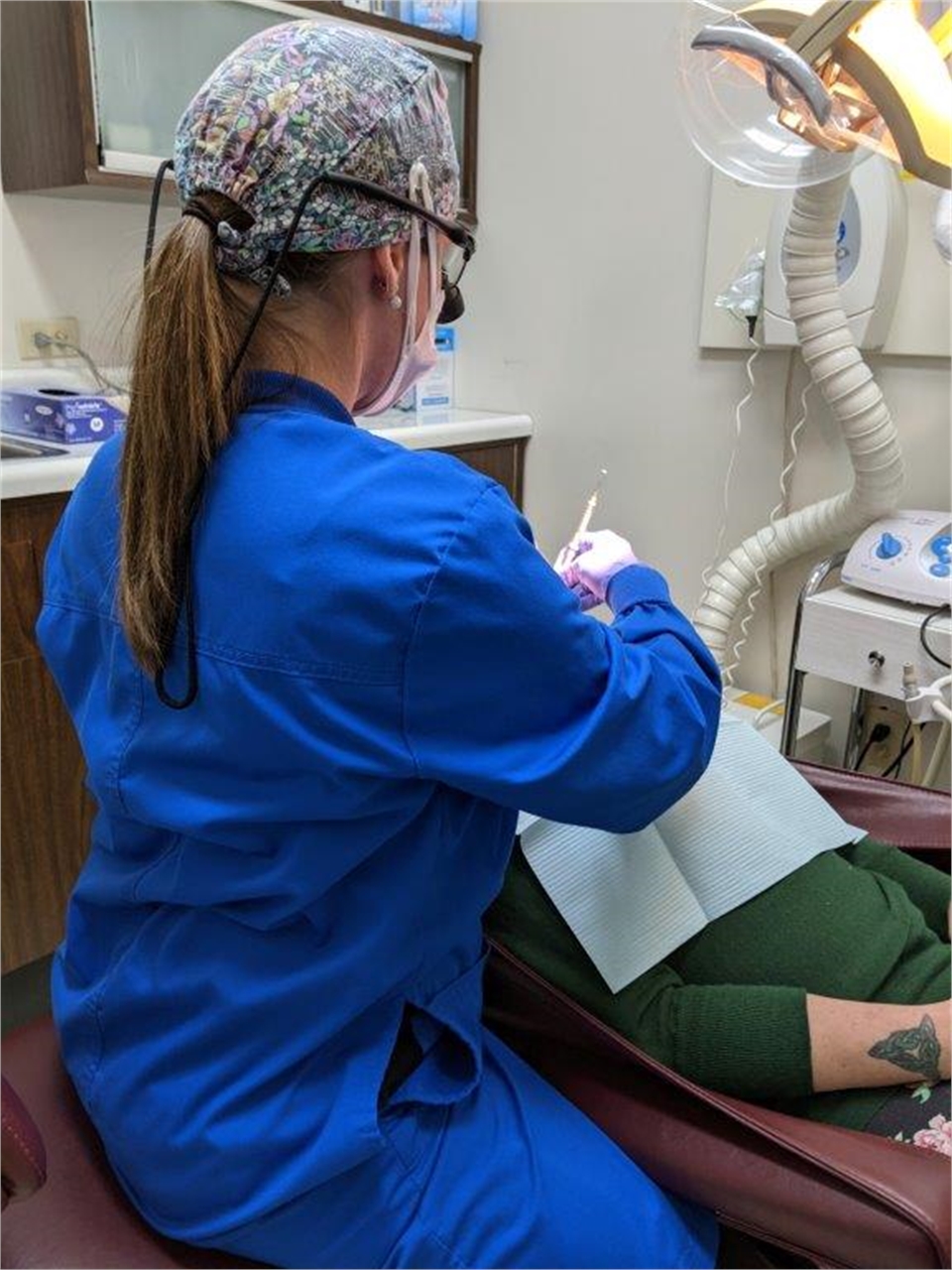 Dental hygienist performing teeth cleaning at Harrison Family Dentists Gloversville NY