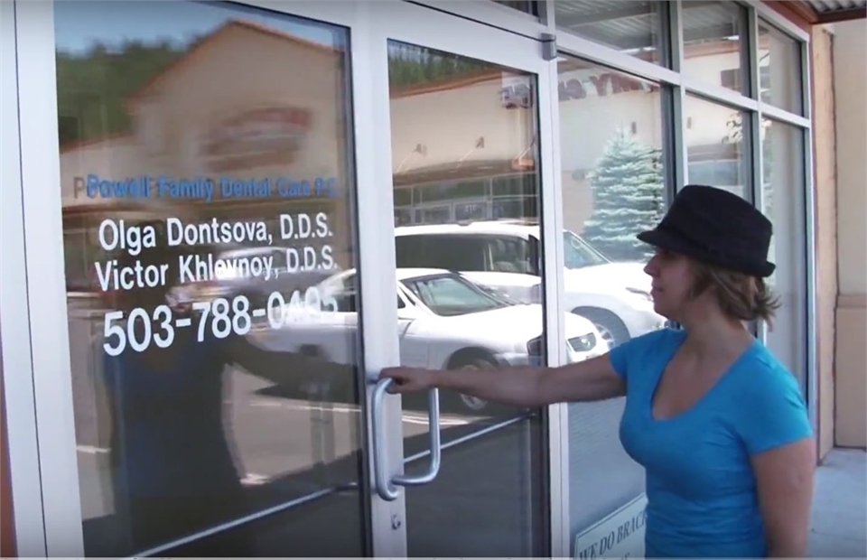 Signage on the glass door at children's dentistry Powell Family Dental Care