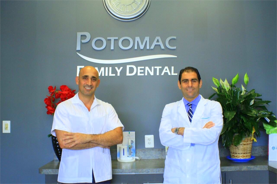 Woodbridge VA dentists Dr. Samer Khattab and Dr. Ahmed Uthman wth Potomac Family Dental signage in t