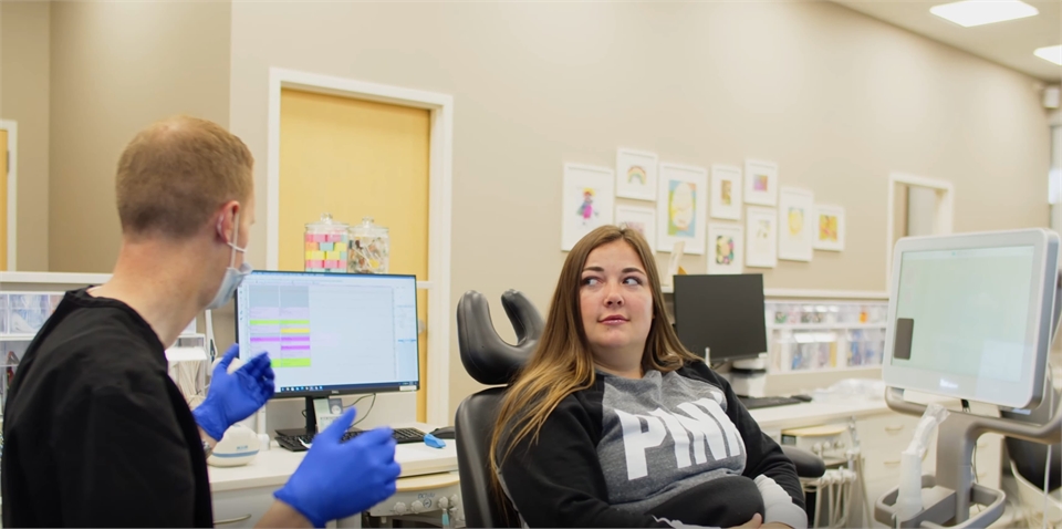 Spokane Valley dentist Dr. Kirk Bean explaining options in braces to patient