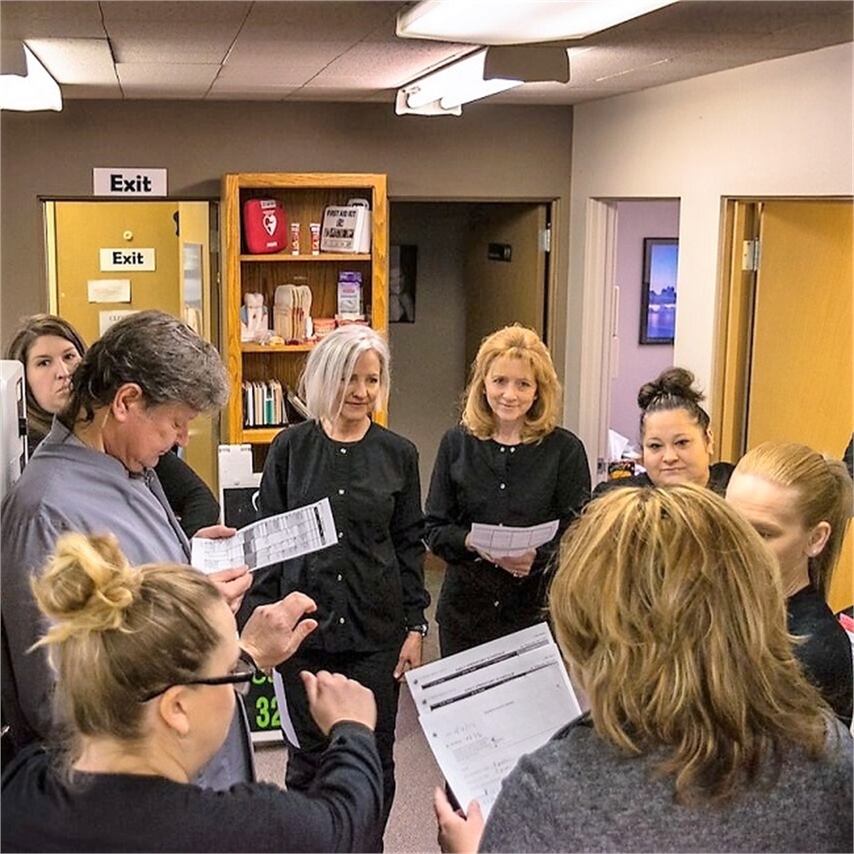 Spokane dentist Jason Keeft planning out the day with his team