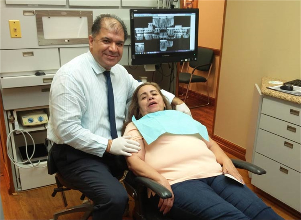 Dr. Behrooz Khademazad with dental implant patient at Grand Prairie Family Dental