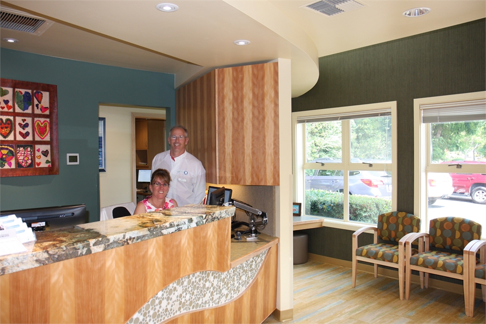 Current Dental Bainbridge dentist Dr. Verharen with front desk staff