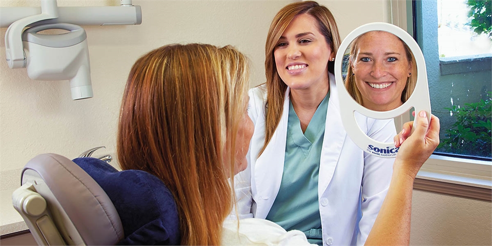 Smile makeover reveal after cosmetic gum treatment at Vruet Periodontics Fort Myers FL