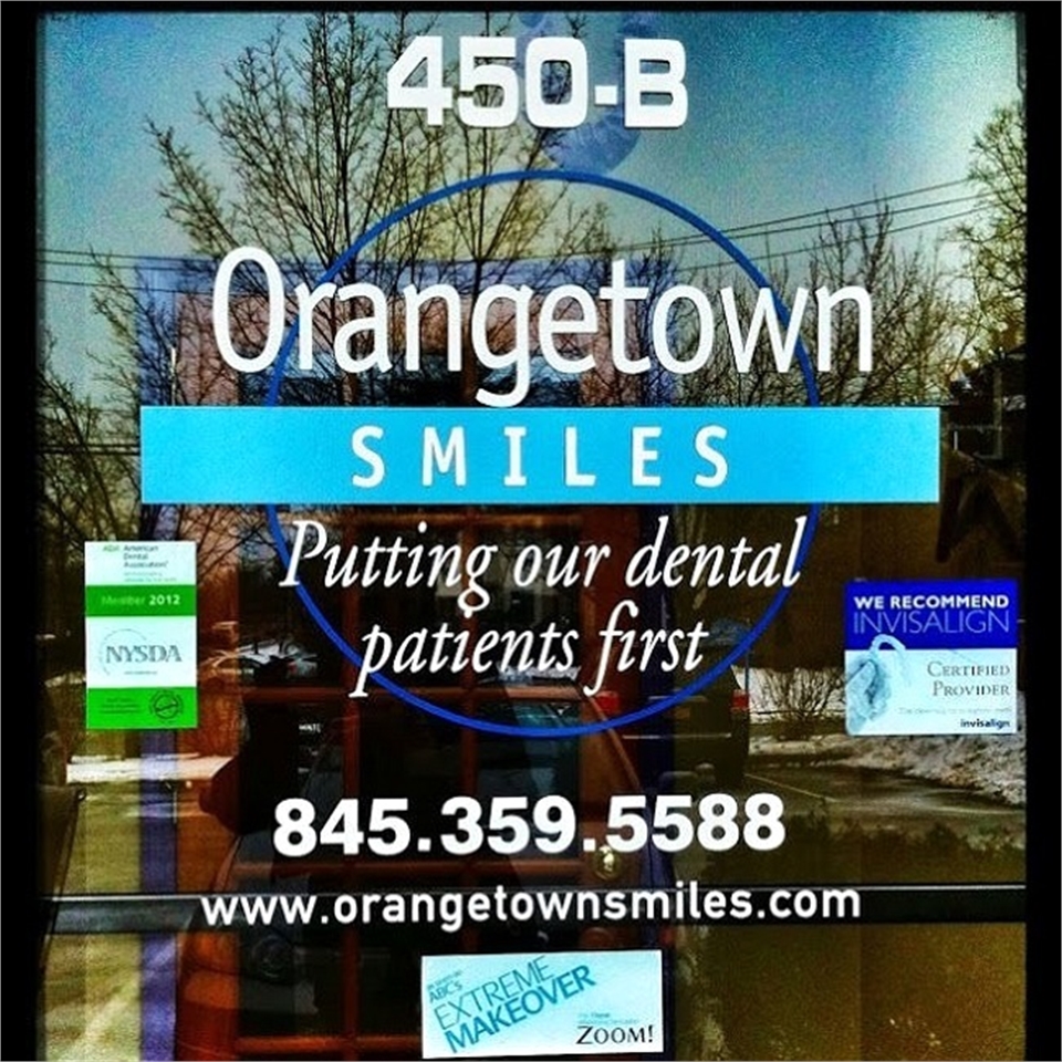 Signage on the glass pane at Orangetown Smiles