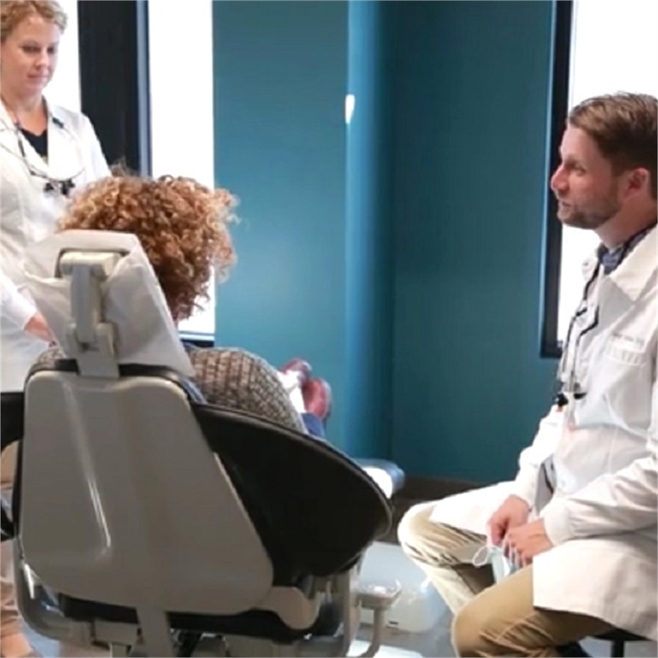 NE Portland dentist Dr. Kathan explains dental implant procedure to patient