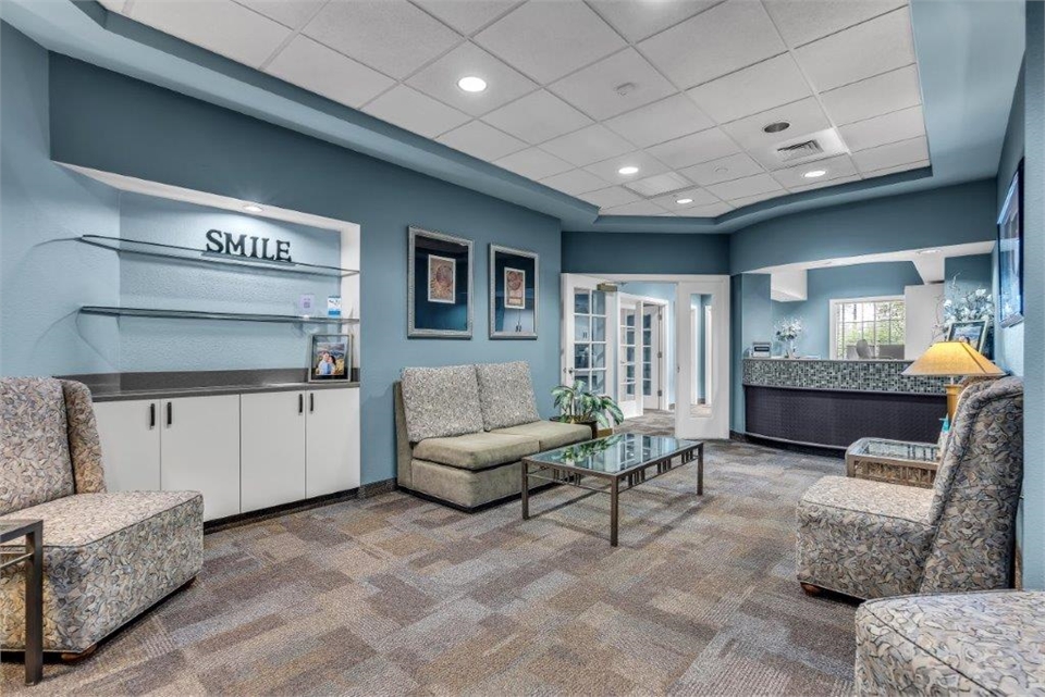 Display shelf in waiting area at Radiant Family Dentistry Scottsdale with reception area in the back