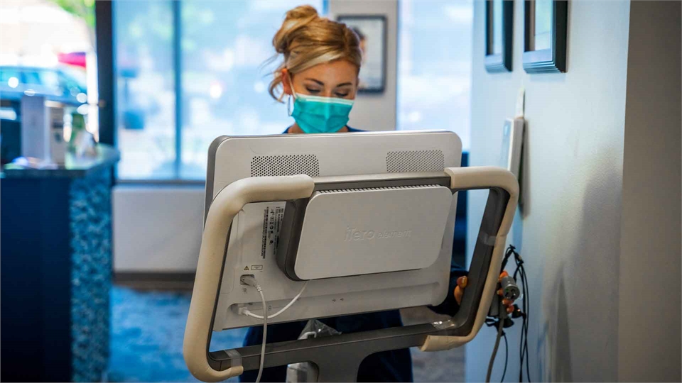 Dental hygienist working on iTero Element for dental crown procedure at Charlotte dentist Family Den