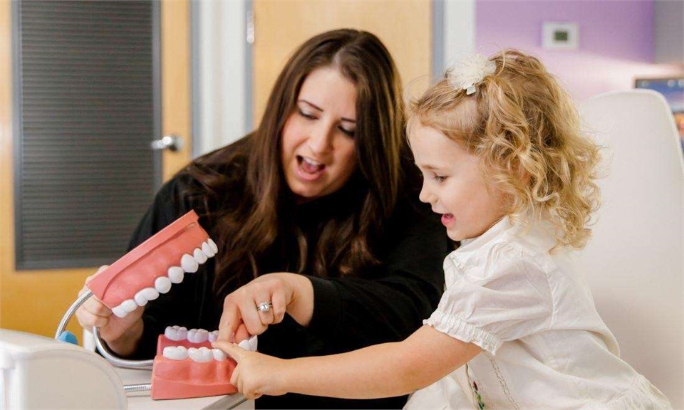 Dr Christen Massey DDS working with a young patient