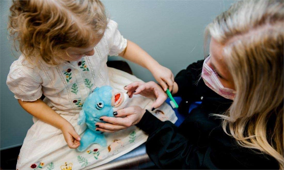 Dental hygienist and pediatric dental patient in Metairie