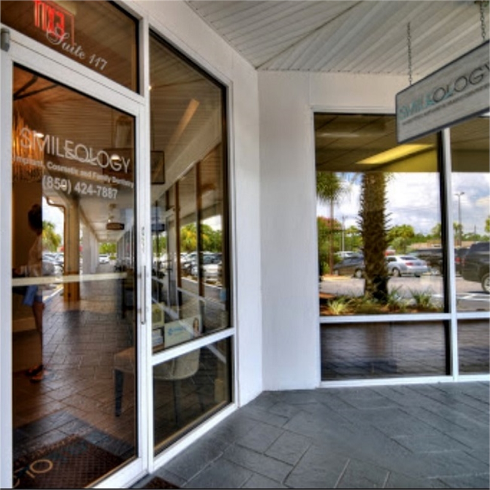 Signage on the front door at Smileology Miramar Beach