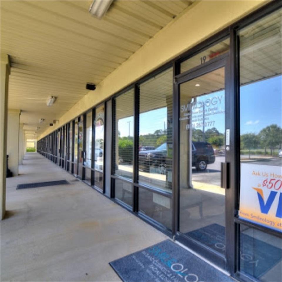 Glass panel with signage at Smileology Santa Rosa Beach