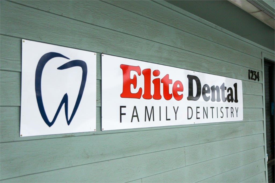 Signage on glass panel at Medford dental implants expert Elite Dental