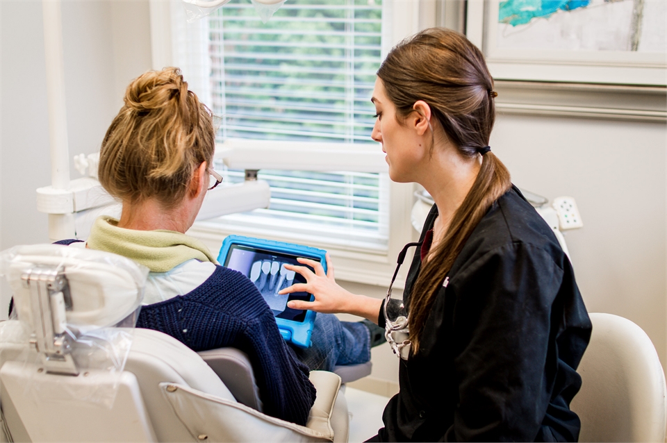 Roswell GA dentist Dr. Lauren Huges of Reich Dental Center with her patient