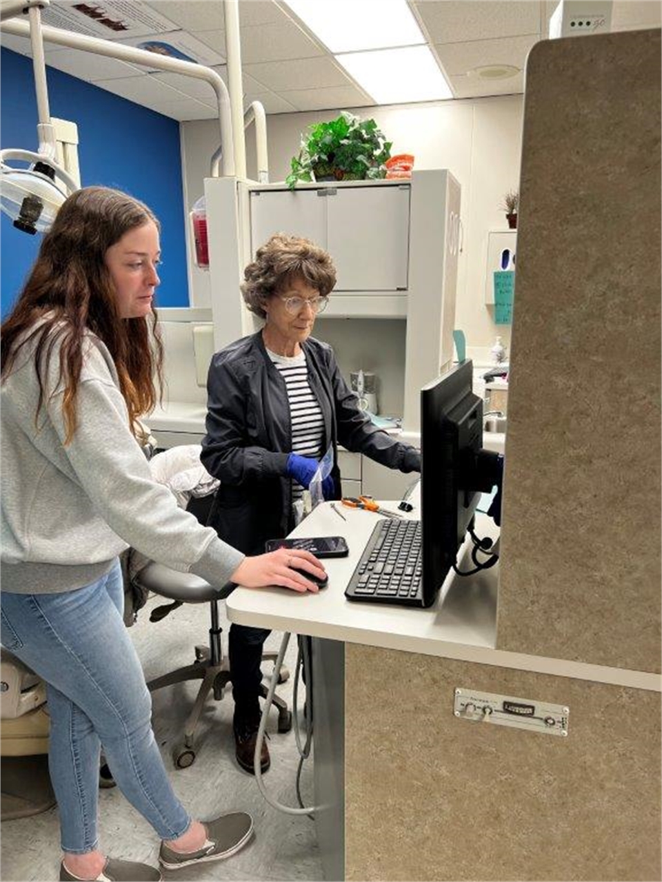 Dental hygienists preparing for dental procedure at Holt Dental Fishers IN