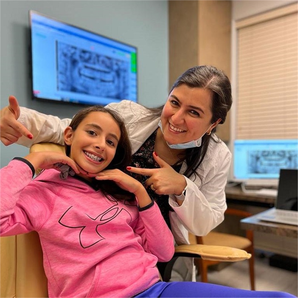 Cedar Park orthodontist Dr. Azi with a pediatric braces patient | Dentagama