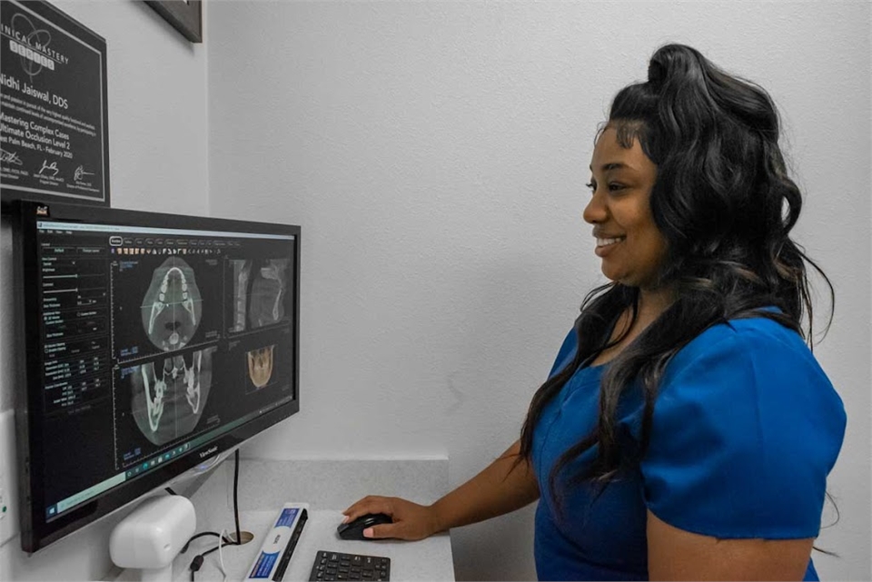 Dental hygienist studying panoramic x-ray images at Starlite Dental McKinney TX