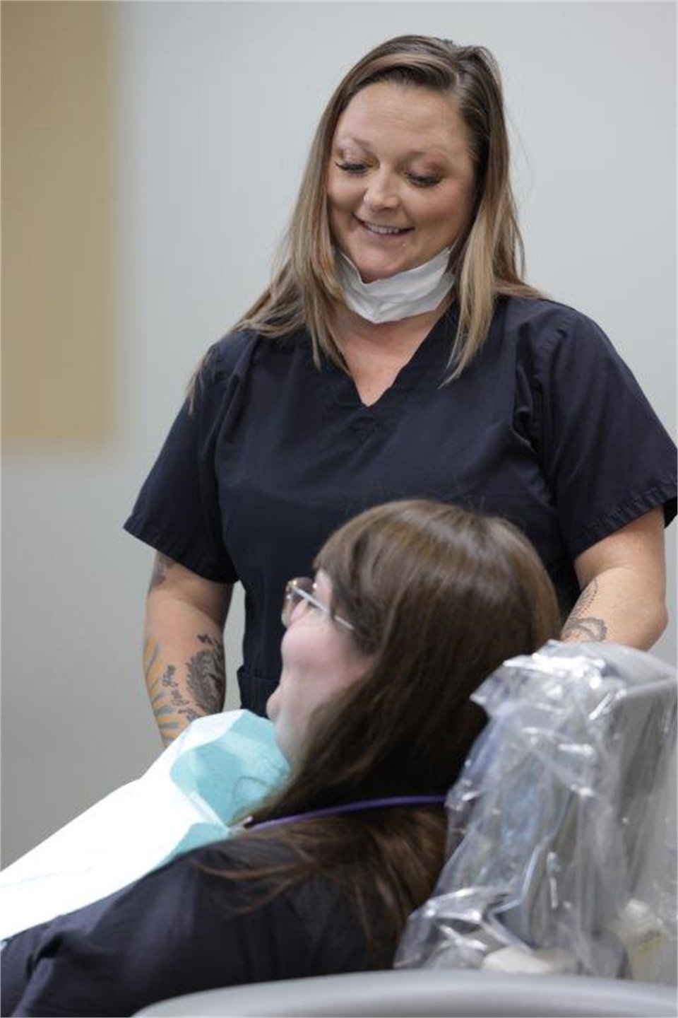 Dental assistant helping emergency patient feel comfortable at True Dental Group