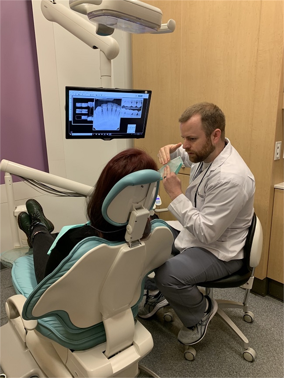 Fayetteville AR dentist Dr. McQueen talking to patient at McQueen Dental