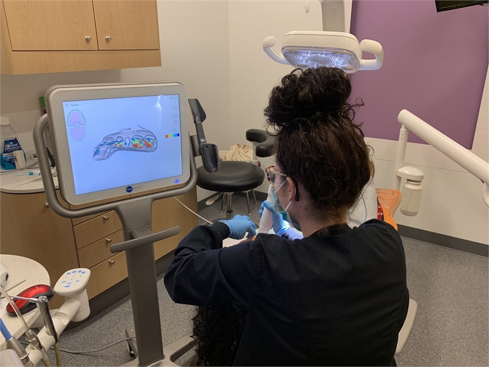 Dental hygienist using iTero Intra Oral Scanner at Fayetteville dentist McQueen Dental