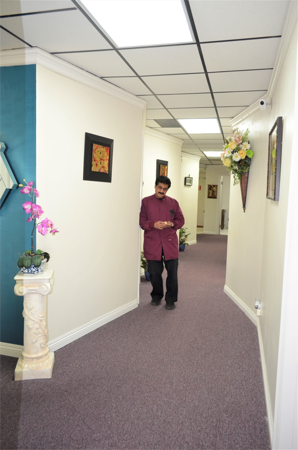 Lake Forest CA dentist Pankaj R. Narkhede  DDS Honored Fellow AAID in the hallway of his dental impl